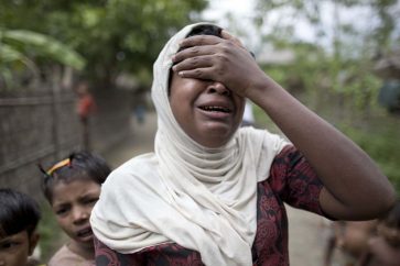 In this Oct. 13, 2015 photo, Salema Khatu reacts after seeing a photograph taken of her son, Habil, months before he died from complications related to tuberculosis in an area for Muslim refugees in north of Sittwe, western Rakhine state, Myanmar. Like other Rohingya Muslims living in Western Myanmar, the 10-year-old was unable to get proper medical treatment. As the predominantly Buddhist nation of 50 million started transitioning from dictatorship toward democracy in 2011, the rise in radical Buddhist nationalism has taking advantage of the newfound freedoms of expression to fan prejudices against the long-persecuted Rohingya Muslim minority. Hate-filled sermons have helped incite violence that began in 2012, leaving hundreds dead and sending a quarter-million others fleeing their homes. (AP Photo/Gemunu Amarasinghe)/XWS138/863246847448/OCT.13, 2015 PHOTO/1511030835