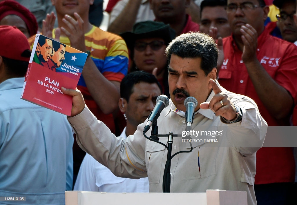 Venezuela's President Nicolas Maduro holds the government's plan for 2025, during a rally at the Miraflores Palace in Caracas, Venezuela on April 6, 2019. - Venezuela's opposition leader Juan Guaido urged his supporters to demonstrate to maintain pressure on Maduro, amid rising anger over the collapse of public services. Pro-Guaido protests drew thousands in rallies across the country, while a pro-Maduro counter-demonstration in Caracas drew thousands of people who marched toward the Miraflores presidential palace. (Photo by Federico Parra / AFP)        (Photo credit should read FEDERICO PARRA/AFP/Getty Images)