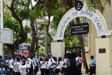 Students walk in front of the Institution Sainte Jeanne D'Arc Catholic school in Dakar, on September 4, 2019. - A renowned Catholic school in Dakar refused to admit to class Muslim students wearing veils under the school's new controversial rule, in a predominantly Muslim country renowned for its religious tolerance. (Photo by Seyllou / AFP)
