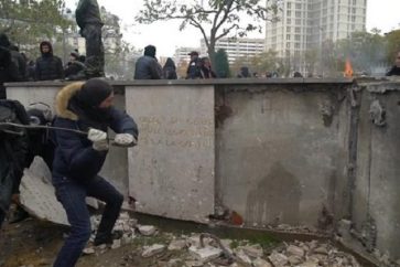 Des casseurs s'attaquent à la barre de fer au monument d'hommage situé place d'Italie à Paris.